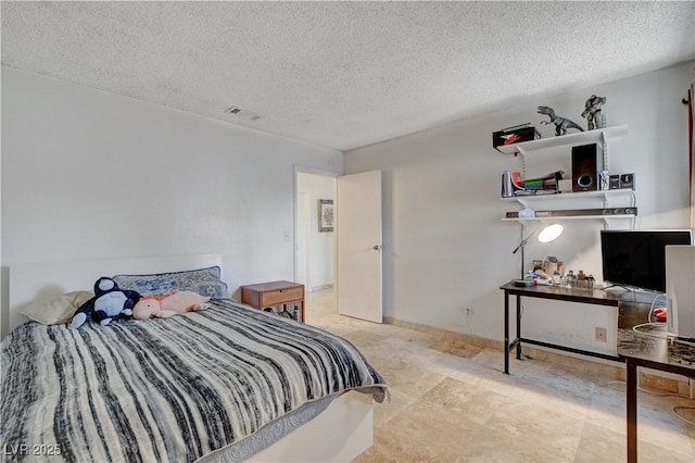 bedroom featuring visible vents and a textured ceiling