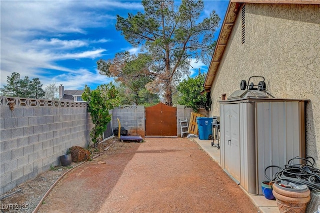 exterior space featuring a gate and a fenced backyard