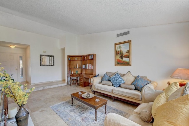 living area featuring visible vents and a textured ceiling