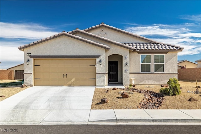 mediterranean / spanish-style house featuring a garage, a tile roof, fence, concrete driveway, and stucco siding