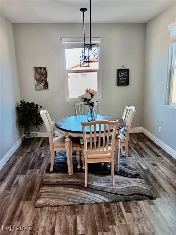 dining area with dark wood-style floors, plenty of natural light, and baseboards