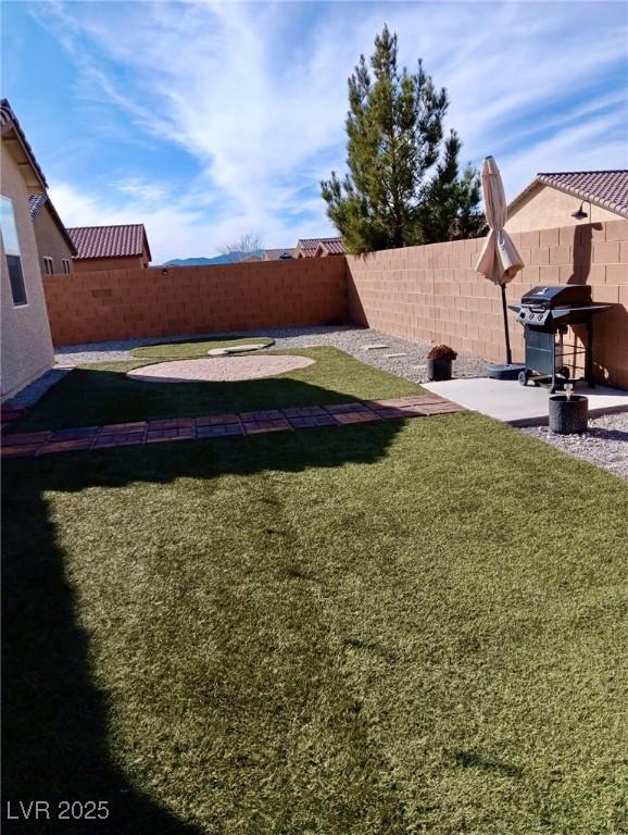 view of yard with a patio area and a fenced backyard