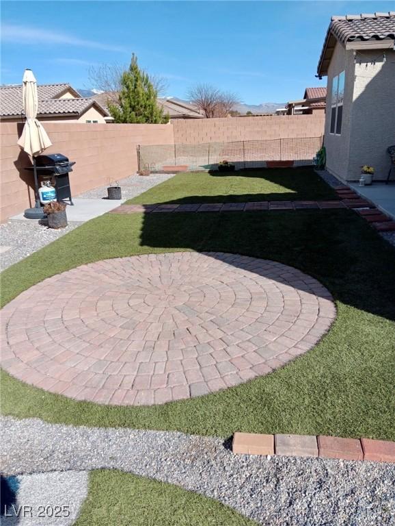 view of yard featuring a fenced backyard and a patio