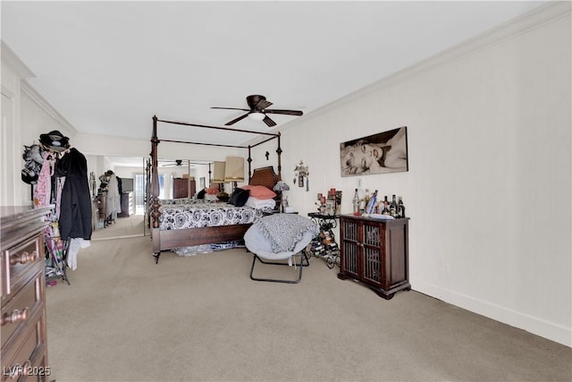 bedroom with carpet floors, ceiling fan, baseboards, and crown molding