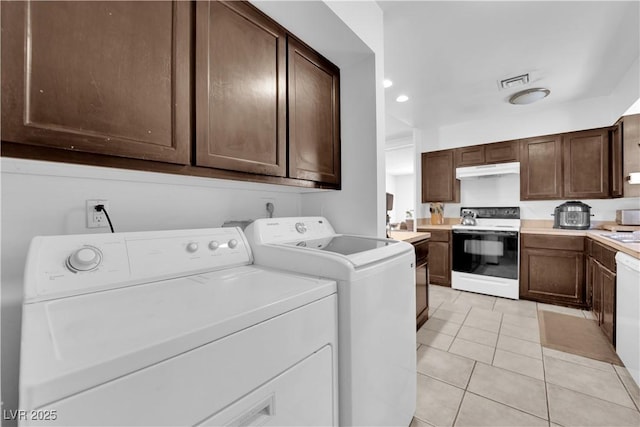 washroom featuring light tile patterned flooring, recessed lighting, laundry area, visible vents, and washer and clothes dryer