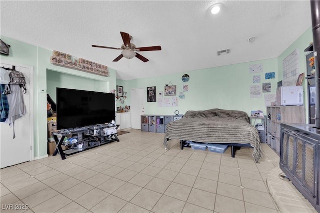 living room with visible vents, ceiling fan, a textured ceiling, and light tile patterned floors