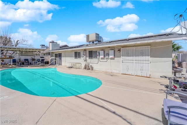 view of pool with a fenced in pool, central AC, and a patio