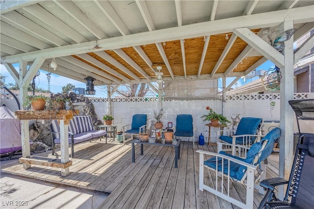 deck with outdoor lounge area and fence