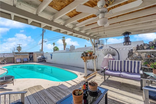 view of swimming pool featuring a fenced backyard, an outdoor hangout area, a fenced in pool, and a wooden deck