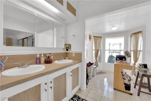 bathroom featuring double vanity, a sink, and tile patterned floors