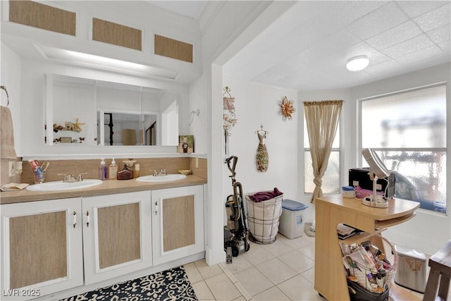 bathroom featuring double vanity, tile patterned flooring, and a sink