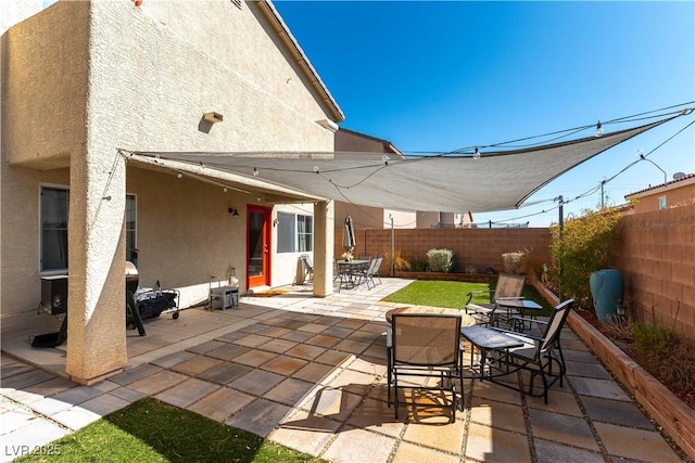 view of patio featuring outdoor dining area and a fenced backyard