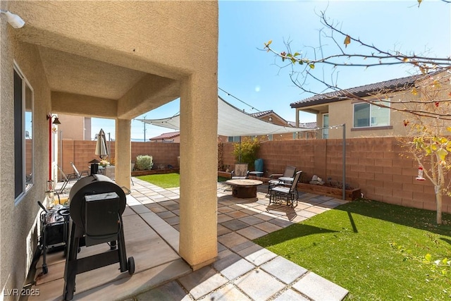 view of patio / terrace featuring an outdoor fire pit and a fenced backyard