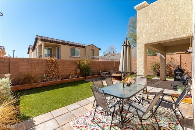 view of patio featuring outdoor dining space and a fenced backyard