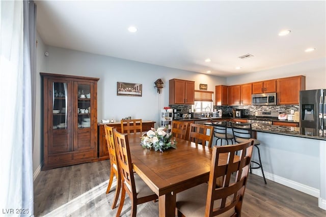 dining room featuring recessed lighting, visible vents, baseboards, and wood finished floors