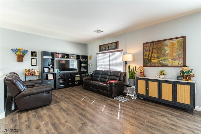 living room featuring visible vents and wood finished floors