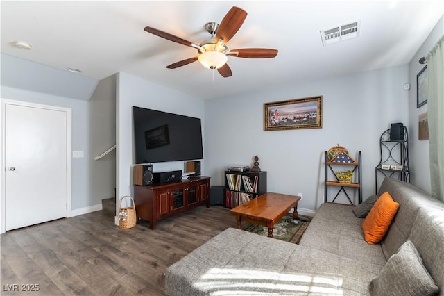 living room with ceiling fan, wood finished floors, visible vents, and baseboards