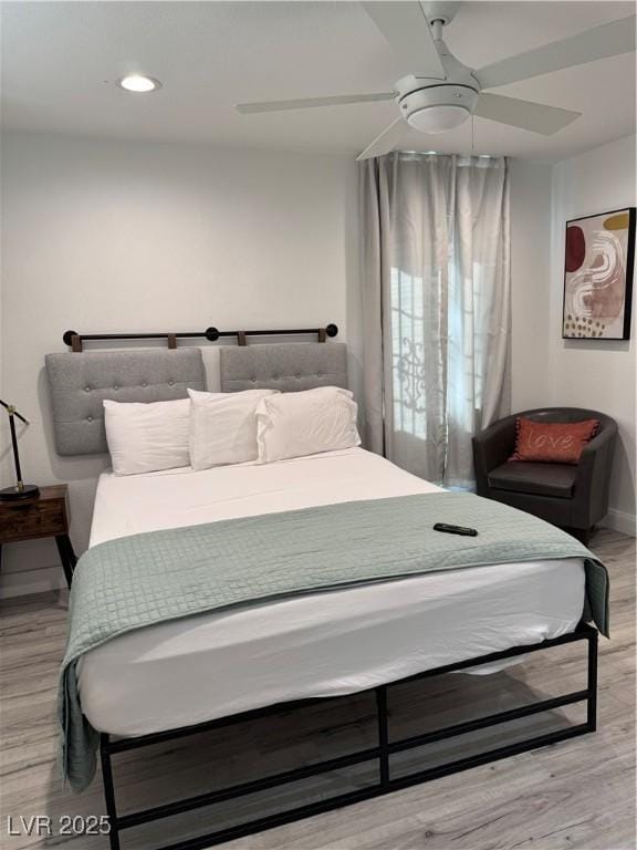 bedroom featuring baseboards, recessed lighting, a ceiling fan, and light wood-style floors