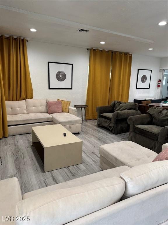 living room with wood finished floors, visible vents, and recessed lighting