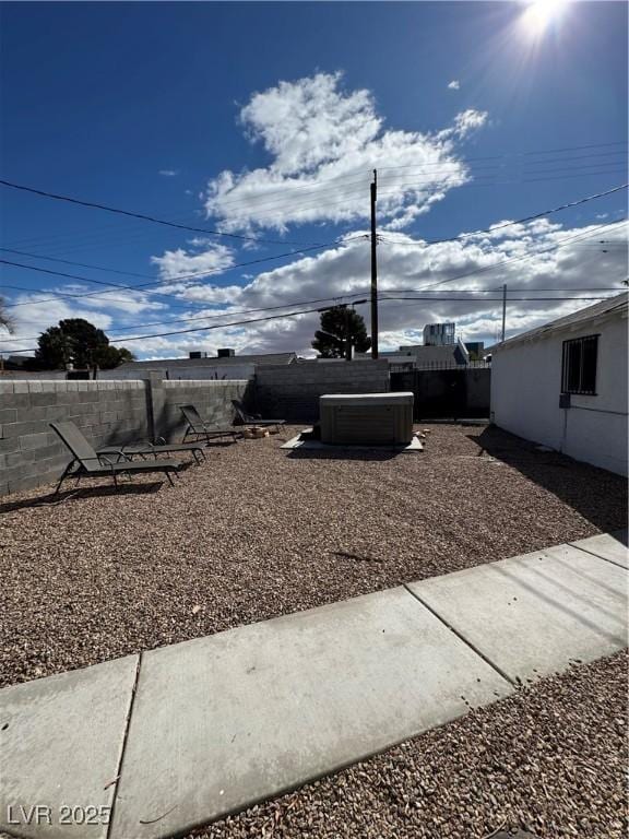 view of yard with central AC and a fenced backyard