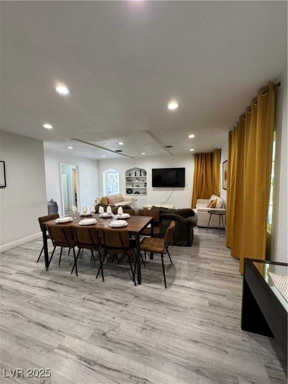 dining room featuring baseboards, recessed lighting, and light wood-style floors