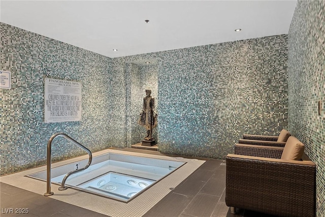 miscellaneous room featuring tile patterned flooring, a hot tub, and tile walls