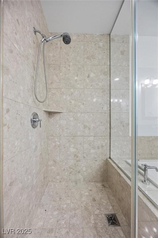 bathroom featuring tiled shower and visible vents