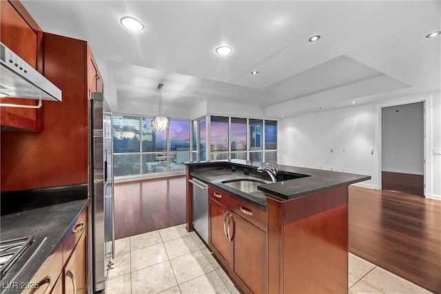 kitchen with light tile patterned flooring, recessed lighting, under cabinet range hood, stainless steel appliances, and a sink