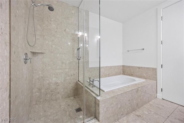 bathroom with a shower stall and a bath