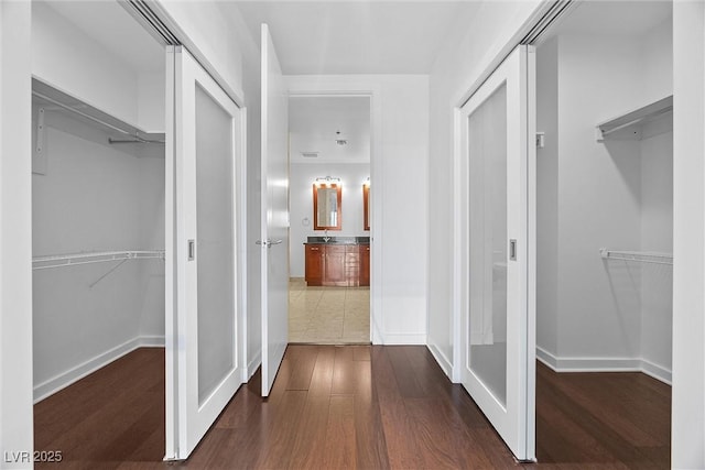 hall featuring dark wood-style floors and baseboards