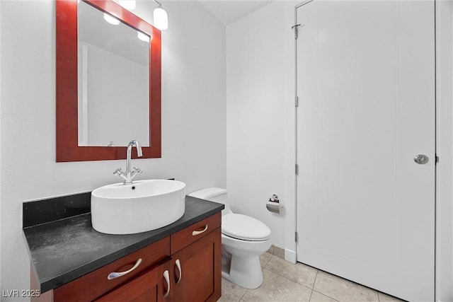 bathroom with vanity, toilet, and tile patterned floors