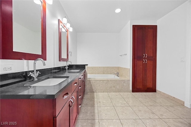 full bathroom featuring a garden tub, double vanity, a sink, and tile patterned floors