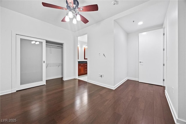 unfurnished bedroom featuring a closet, wood finished floors, and baseboards