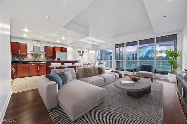 living room featuring a chandelier, recessed lighting, and wood finished floors