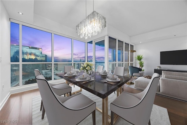 dining area with a chandelier, recessed lighting, and wood finished floors