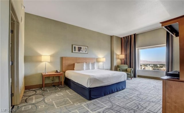 carpeted bedroom featuring baseboards