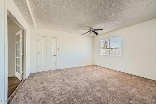 empty room with a textured ceiling, a ceiling fan, and carpet flooring