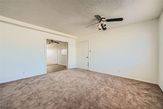 unfurnished room with carpet, ceiling fan, and a textured ceiling