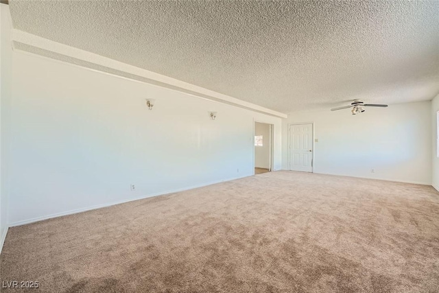 spare room with a ceiling fan, carpet flooring, and a textured ceiling