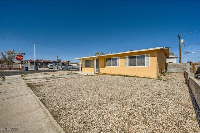 view of front of property with fence and stucco siding