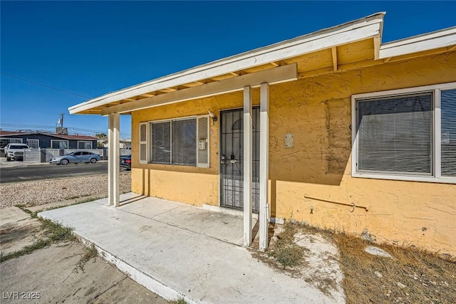 doorway to property with stucco siding