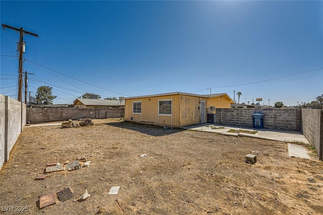 rear view of property featuring a fenced backyard