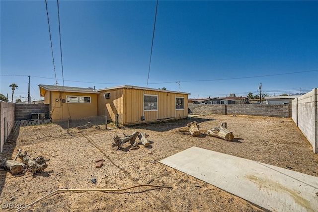 back of house with a fenced backyard