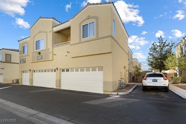 view of property exterior featuring an attached garage and stucco siding