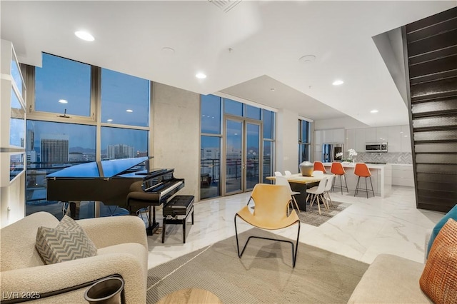 living area with marble finish floor, a wall of windows, and recessed lighting