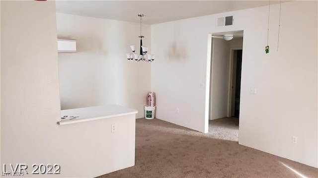 interior space featuring a chandelier, carpet floors, and visible vents