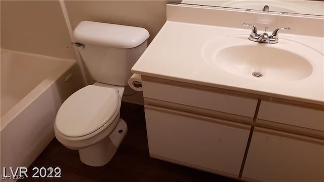 bathroom featuring toilet, a bathtub, walk in shower, and vanity