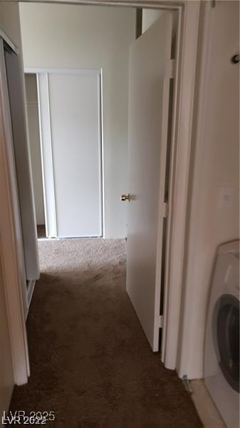 hall featuring washer / dryer and carpet floors