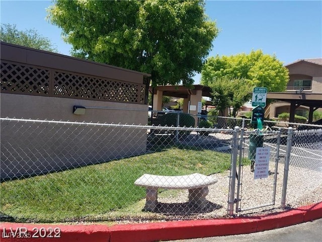 view of community with a lawn and fence