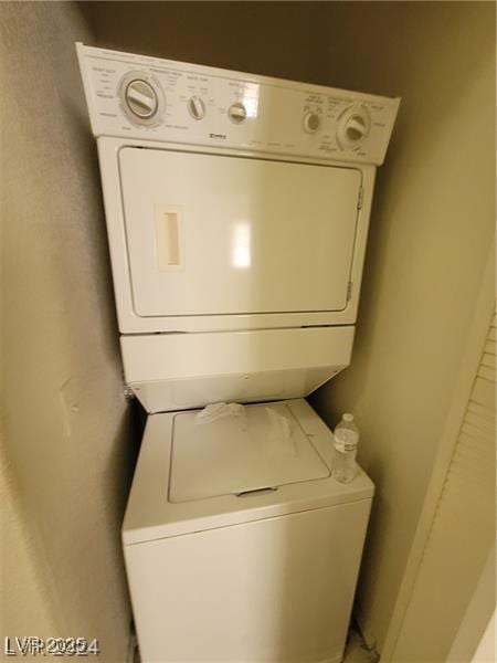 laundry room with stacked washer and dryer and laundry area